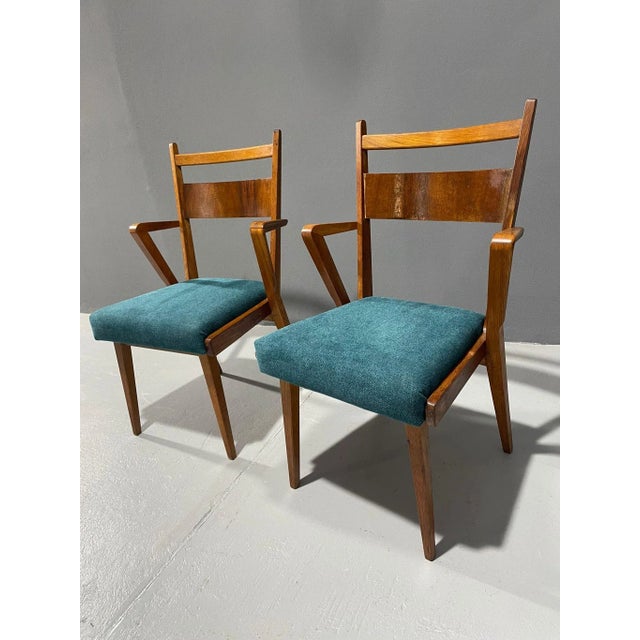 This pair of upholstered armchairs was produced by Jitona in Czechoslovakia during the 1970s. The chairs have a bent...