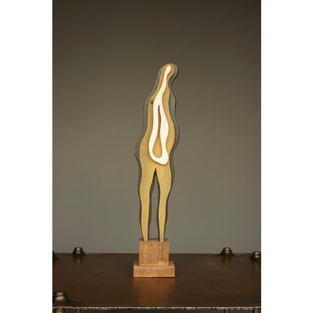 An unusual sculpture in the surrealist style that uses the motif of a standing figure.