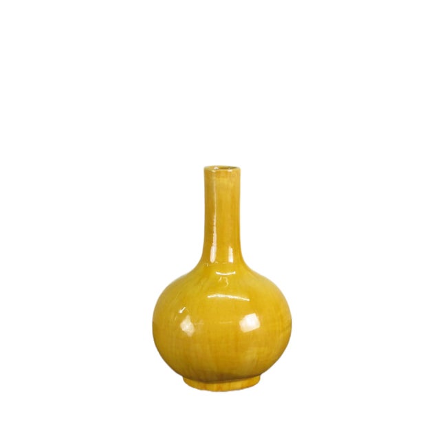 This yellow long neck vase boasts a sleek and slender form. Handcrafted and hand glazed shows natural variance of glaze...