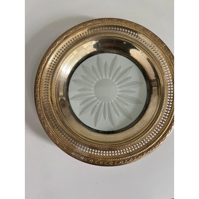 This elegant vintage bottle coaster features a reticulated pierced sterling silver rim with an ornate repoussé border,...