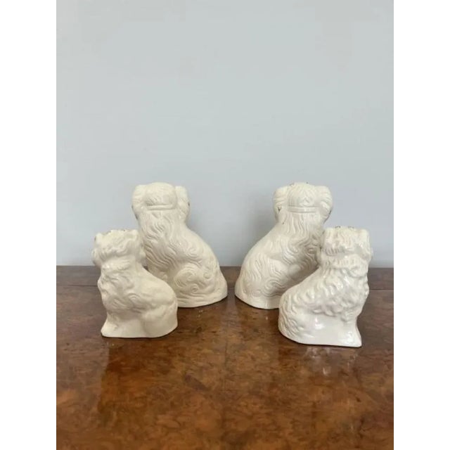 Four quality Royal Dolton seated spaniels having a collection of four quality Royal Dolton seated spaniels with white...