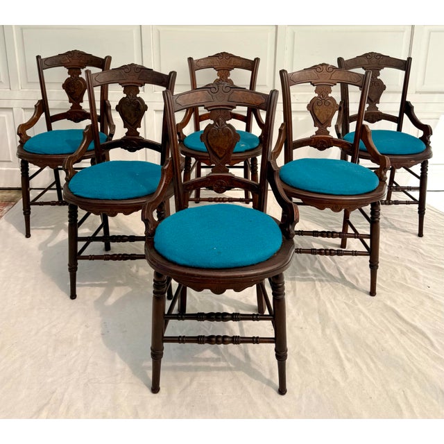 Here is a handsome set of six antique dining chairs, likely dating to the late 19th to early 20th century, featuring...