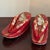 An adorable small pair of traditional Japanese wooden Geta shoes from the mid-20th century. These Geta feature a red...