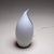 Small Murano glass table lamp with a white, drop-shaped body with air bubble inclusions and a black line.