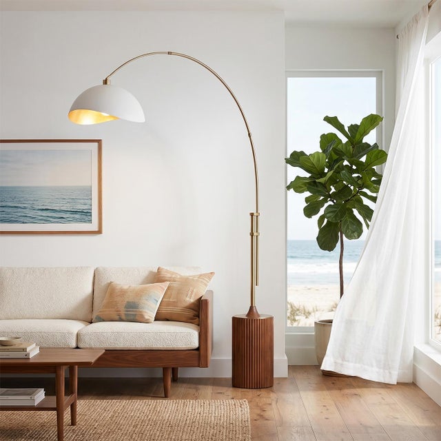 The Tambo Arc Lamp is a dimmable mid-century modern arc lamp with a weathered brass steel body, offering adjustable light...