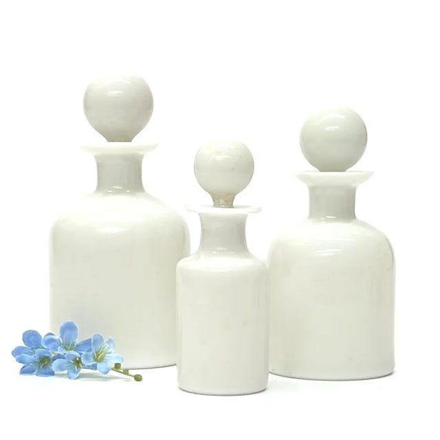 White glass bottle curation, group of 3. A gorgeous and delicate group of antique French Portieux Vallerysthal hand-blown,...