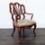 Elegant Chippendale-style armchair crafted in a rich mahogany finish with a pierced ribbon-back splat, carved shell...