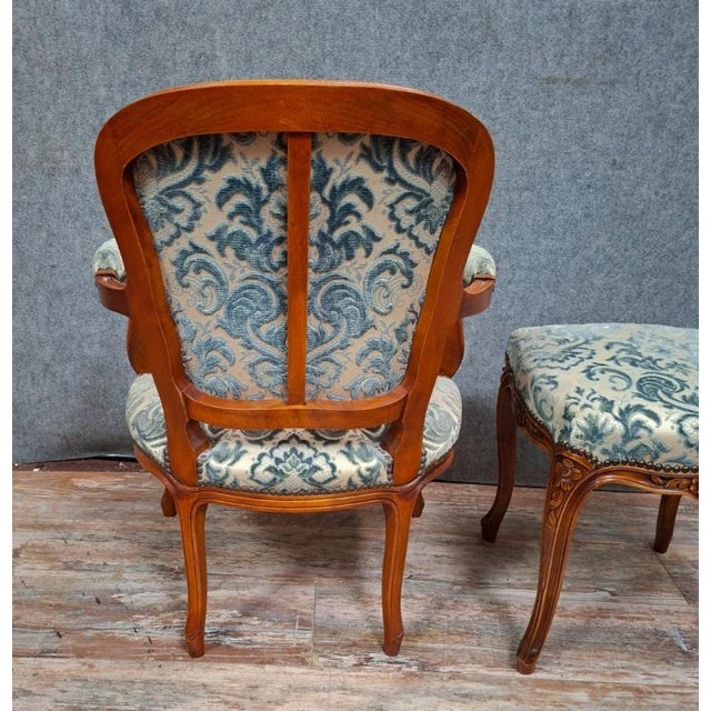 Cherrywood cabriolet armchair with footstool, 20th century, louis xv style an elegant set comprising a cabriolet armchair...