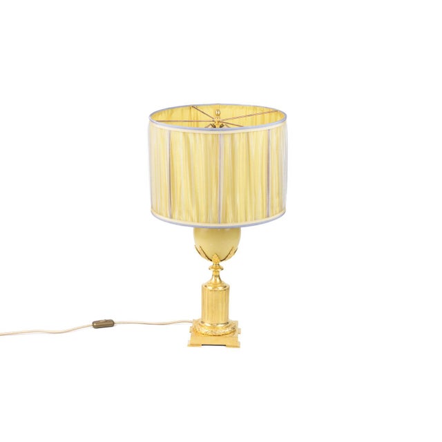 Maison charles, attributed to. Ostrich egg lamp in earthenware and gilt bronze. Shaft in white ostrich egg shape framed by...