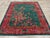This mid-20th century Chinese Art Deco rug, features a striking emerald green field adorned with an intricate floral...