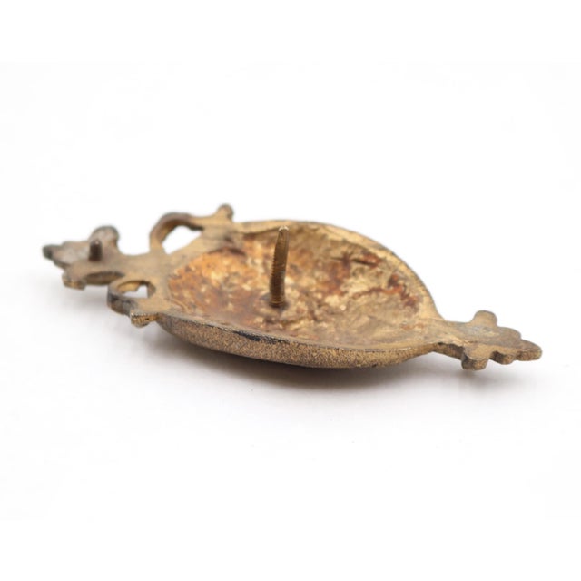 Neoclassical style small scale furniture applique made of brass. It features a high relief profile portrait of a Roman...