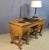 A 20th-century Amboyna burl dressing table/desk. This highly original and beautifully crafted piece rests on eight legs...