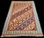 A stunning handcrafted Afghan kilim featuring an elegant geometric diamond design enclosing traditional tribal-inspired...