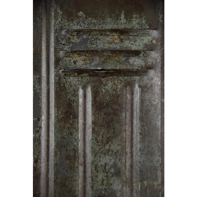 This industrial, metal factory cabinet was produced during the 1950s. The wardrobe has three doors with ventilation...