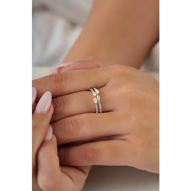 This crisscross double band ring showcases 0.65 carats of natural diamonds, set in 14K yellow gold. The diamonds are set...