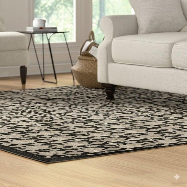 This black wool rug features a traditional hand knotted pile weave and originates from China. The construction utilizes...