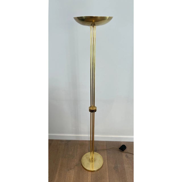 This beautiful designer floor lamp is made entirely of brass. It is a French work in the Art Deco style. Circa 1970