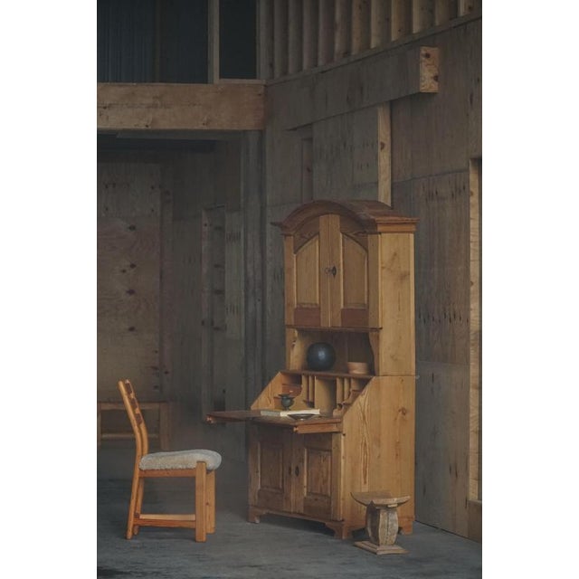 A charming Antique Danish drop-front secretary in solid pine, dating to the mid 19th century. The piece features a well-...