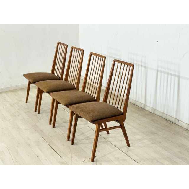 For sale is a set of four vintage dining chairs by Hellerau from the 1960s. The chairs impress with their delicate design,...