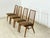 For sale is a set of four vintage dining chairs by Hellerau from the 1960s. The chairs impress with their delicate design,...