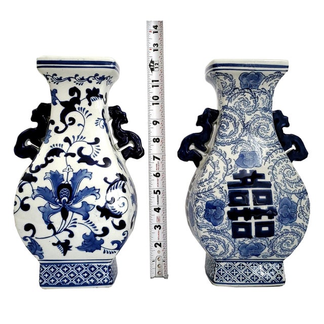 Offering a pair of vintage Chinese blue and white porcelain vases, circa Late 20th Century. These Chinese vases are...