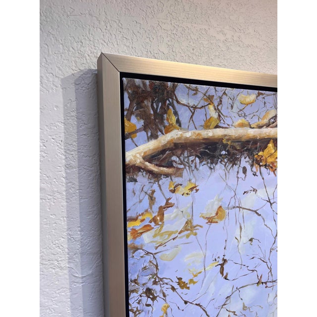 This oil on canvas artwork captures a serene reflection on water, where intertwining branches and scattered leaves create...