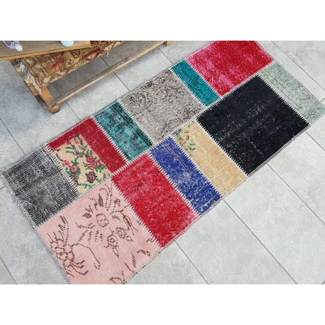 This is a vintage Turkish Oushak rug from the Mid 20th Century. The piece was hand-knotted.