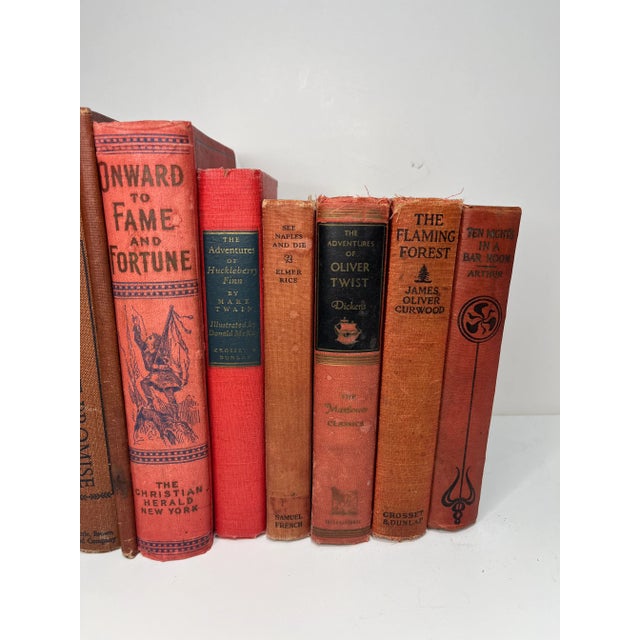 Set of 12 vintage and antique books in shades of red. Varying subject matters and sizes. Condition varies and most are...