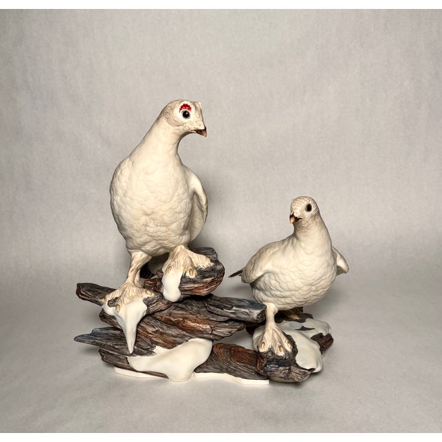 Limited-edition porcelain bird grouping by Boehm Porcelain, depicting ptarmigan in winter plumage perched on snow-covered...
