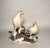 Limited-edition porcelain bird grouping by Boehm Porcelain, depicting ptarmigan in winter plumage perched on snow-covered...