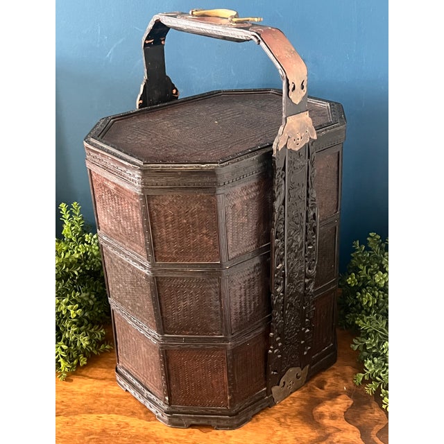 A striking and substantial antique Chinese wedding basket, executed in black lacquer over finely woven panels and accented...