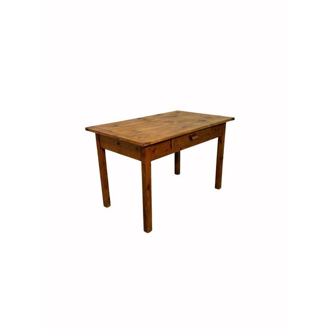 Early 20th-century kitchen table made of fir, with simple, functional lines typical of everyday furnishings in homes of...