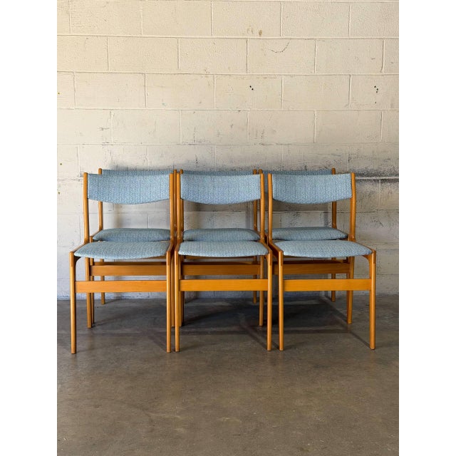 This elegant set of six dining chairs features a clean architectural frame with gently curved backrests. The minimalist...
