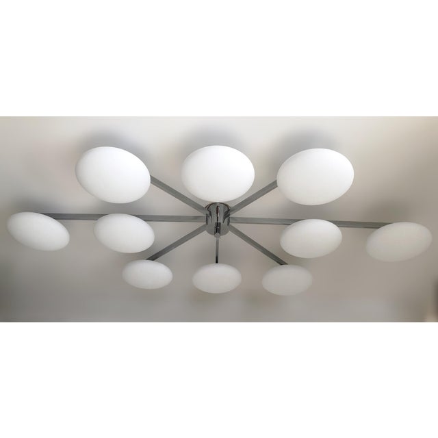 Italian midcentury flush mount with ten matte white Murano glass shades mounted on solid brass frame in polished chrome...