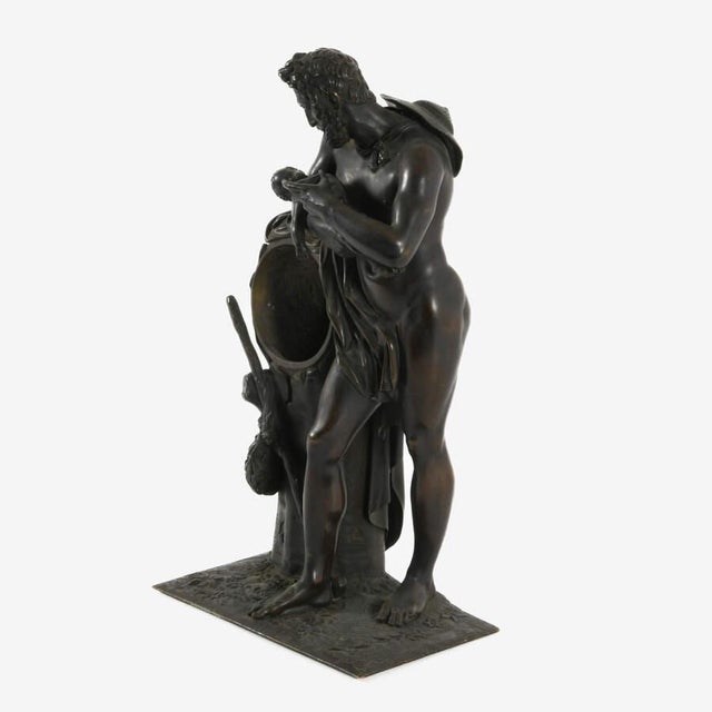 This antique bronze sculpture depicts a classical mythological scene of Silenus nurturing the young Bacchus, a subject...