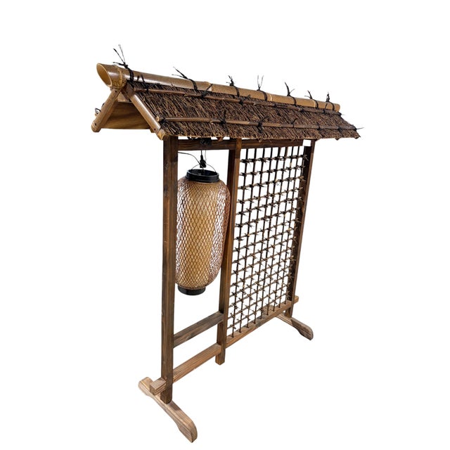 A striking vintage Japanese floor lamp handcrafted from burnt bamboo, featuring an intricate lattice frame and traditional...