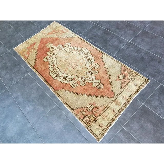 This is a vintage Turkish Oushak rug from the 1960s. The piece was hand-knotted.