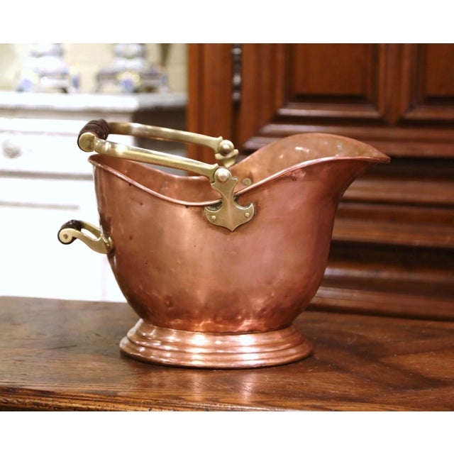 This antique coal scuttle was created in England, circa 1880. Built of copper with a brass and turned walnut handle, the...
