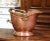 This antique coal scuttle was created in England, circa 1880. Built of copper with a brass and turned walnut handle, the...