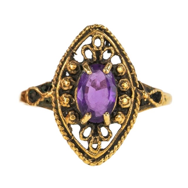 Vintage 14K Gold Oval Amethyst Cocktail Ring. Ring features a faceted oval purple amethyst surrounded by beautifully...