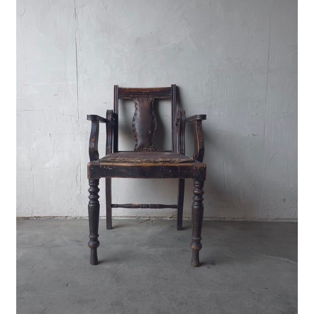 This antique piece is an Edwardian style barber's chair with adjustable back. Crafted from turned hardwood with a...