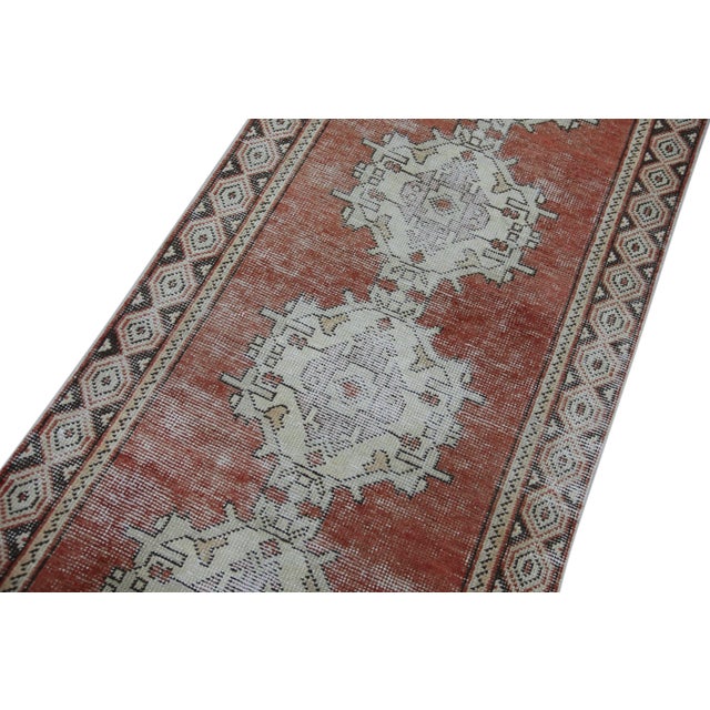 Introducing a one-of-a-kind vintage Turkish hand-knotted wool rug, carefully crafted by skilled artisans using traditional...
