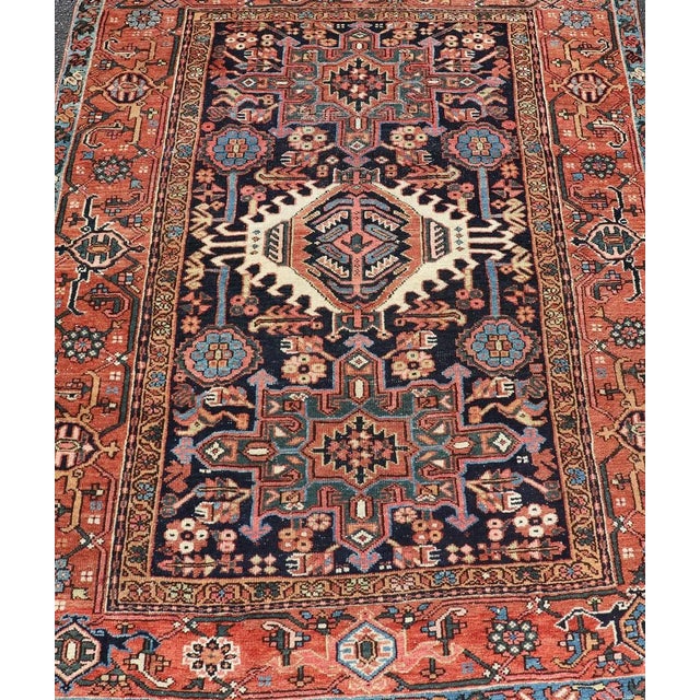 This lovely Antique Heriz rug, hailing from northwestern Iran (circa 1920s), features a central medallion design...