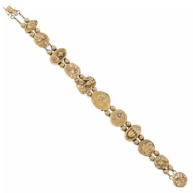 This charming vintage Art Nouveau bracelet is crafted from 14k yellow gold featuring assorted size and shape hallow cameo...