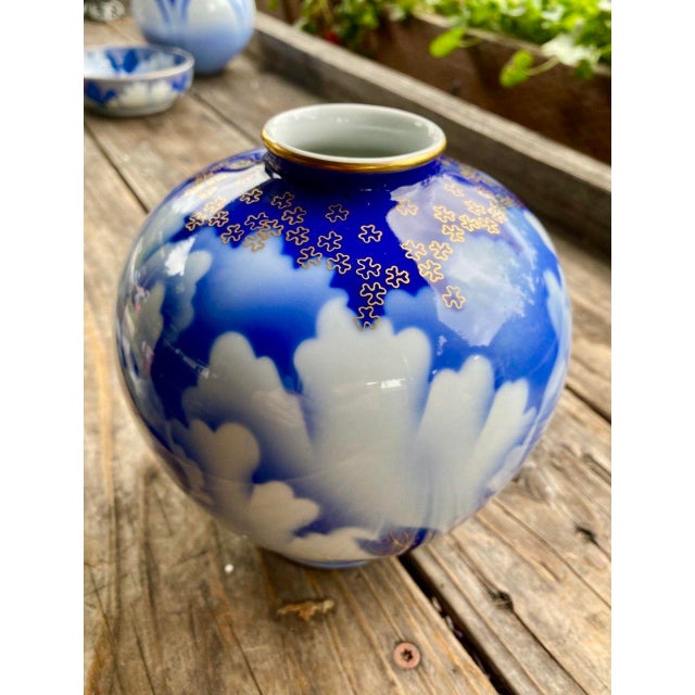Elegant vintage Japanese porcelain vase decorated in luminous cobalt blue and white with large stylized peony blossoms and...