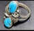 Native American double feather ring, stamped "D" by the Navajo artist, John Delvin. The ring displays two vibrant powdery...