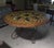 Large round table with a scagliola-style painted wooden top – Wrought iron base This substantial round decorative table...
