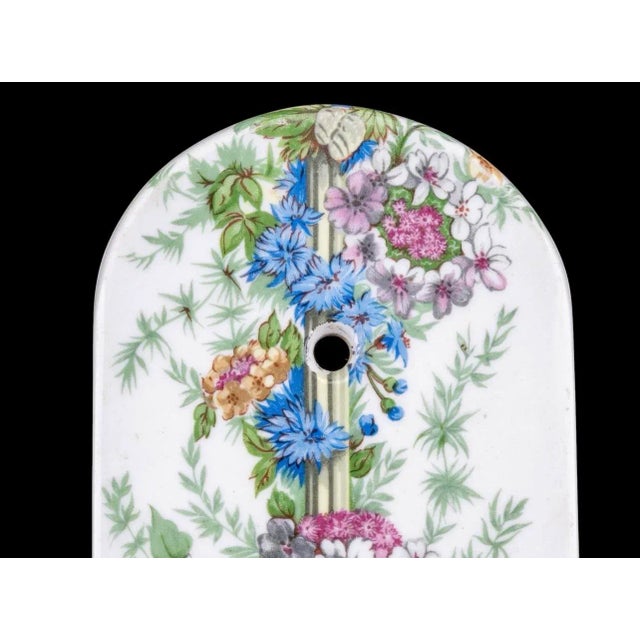 A breathtaking pair of vintage Porcelaine de Paris wall sconces, exquisitely hand-decorated with delicate floral garlands...