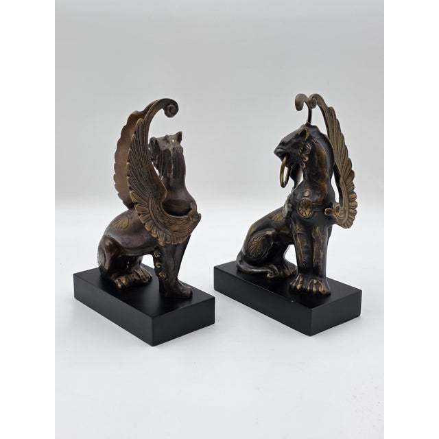 This rare pair of antique late 19th-century heavy bronze Griffin bookends/candleholders exudes a sense of history and...