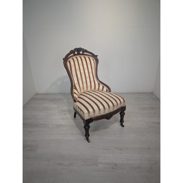 A unique Victorian-style armchair, captivating with its elegant form, rich ornamentation, and timeless character. A...